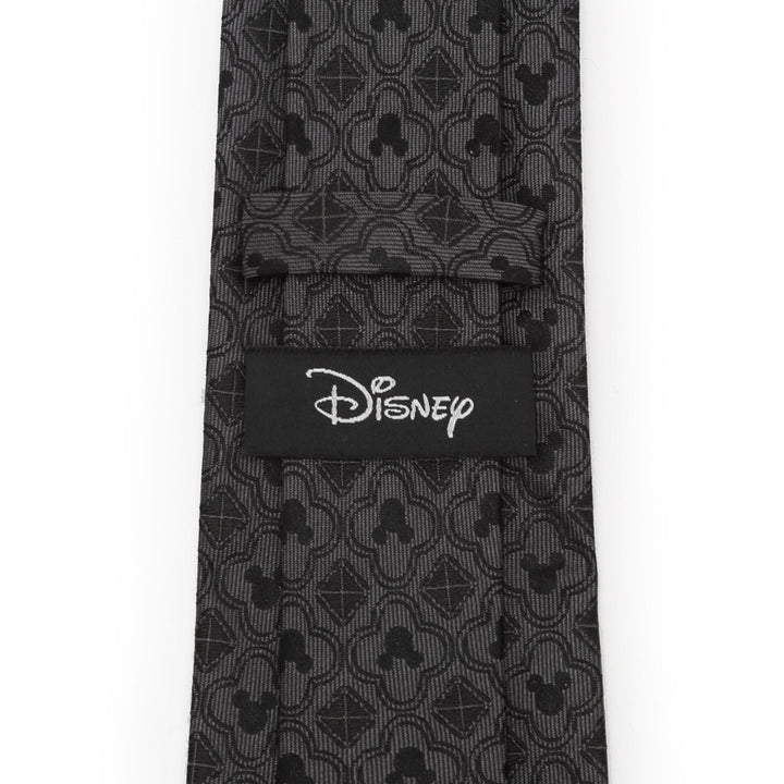 Disney Mickey Mouse Pattern Black Men’s Tie with a gray repeating Mickey Mouse silhouette pattern and a Cufflinks.com brand label on the back.