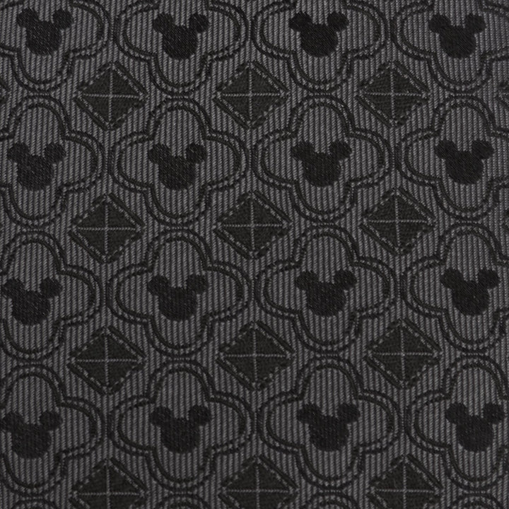 Disney Mickey Mouse Pattern Black Men’s Tie in black silk featuring a repeating dark grey pattern of Mickey Mouse silhouettes inside quatrefoil shapes and small squares.