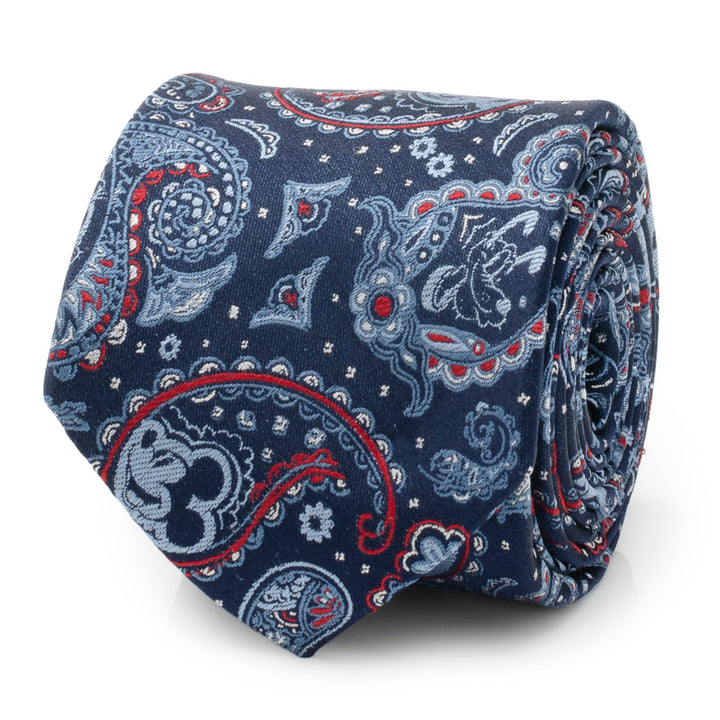 A coiled Disney Mickey and Friends Paisley Blue Multi Men’s Tie in navy blue silk, featuring a repeating paisley pattern with hidden Mickey Mouse silhouettes in red, light blue, and white.