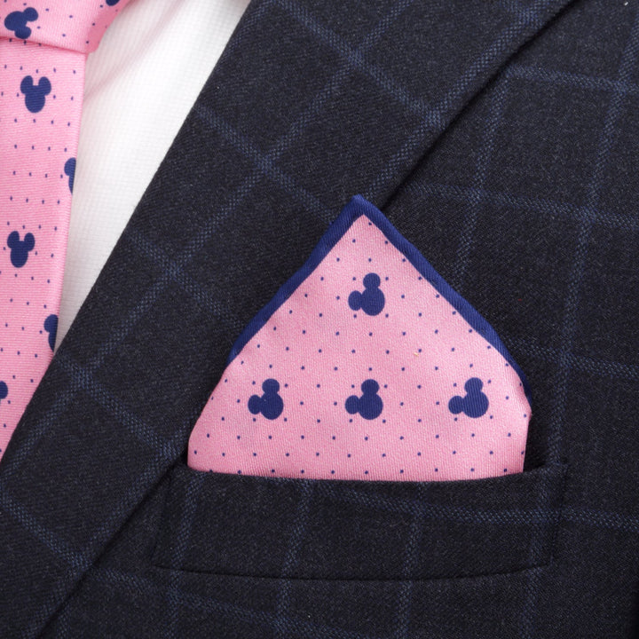 Disney Mickey Mouse Dot Pink Pocket Square with blue Mickey Mouse silhouettes and small dots, tucked into the breast pocket of a navy plaid suit jacket.