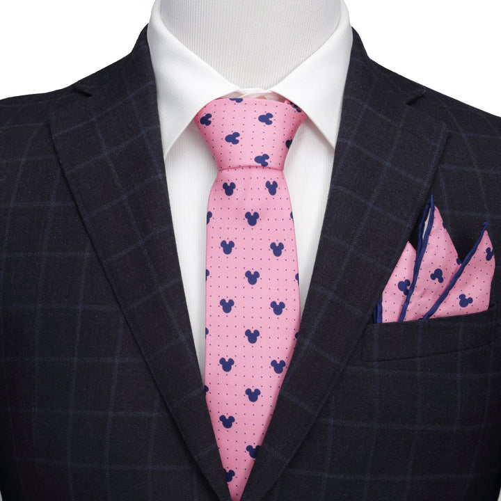 A Disney Mickey Mouse Dot Pink Men’s Tie and matching pocket square worn with a white dress shirt and dark plaid suit jacket.