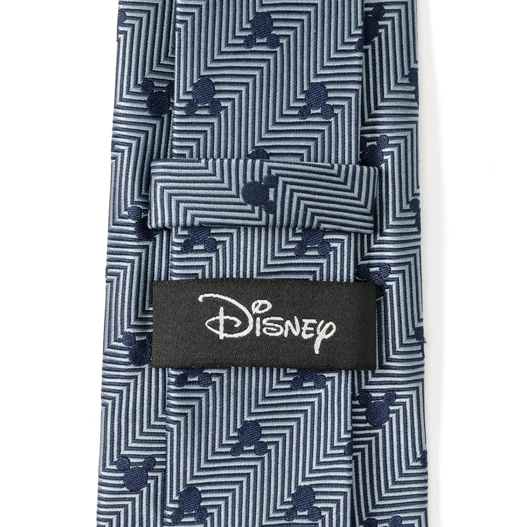 Disney Mickey Mouse Silhouette Blue Herringbone Men’s Tie in blue silk with a dark blue geometric pattern, small Mickey Mouse silhouettes, and a black Cufflinks.com brand tag.