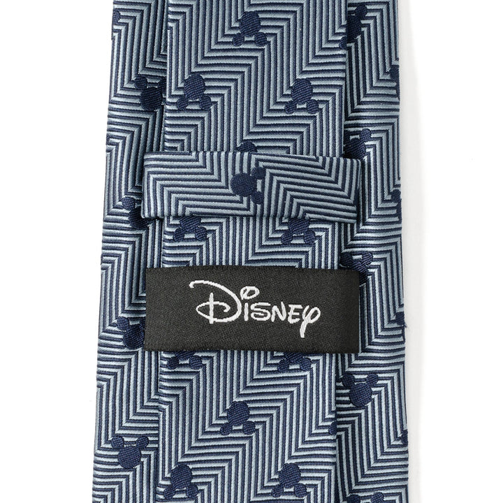 Disney Mickey Mouse Silhouette Blue Herringbone Men’s Tie in blue silk with a dark blue geometric pattern, small Mickey Mouse silhouettes, and a black Cufflinks.com brand tag.