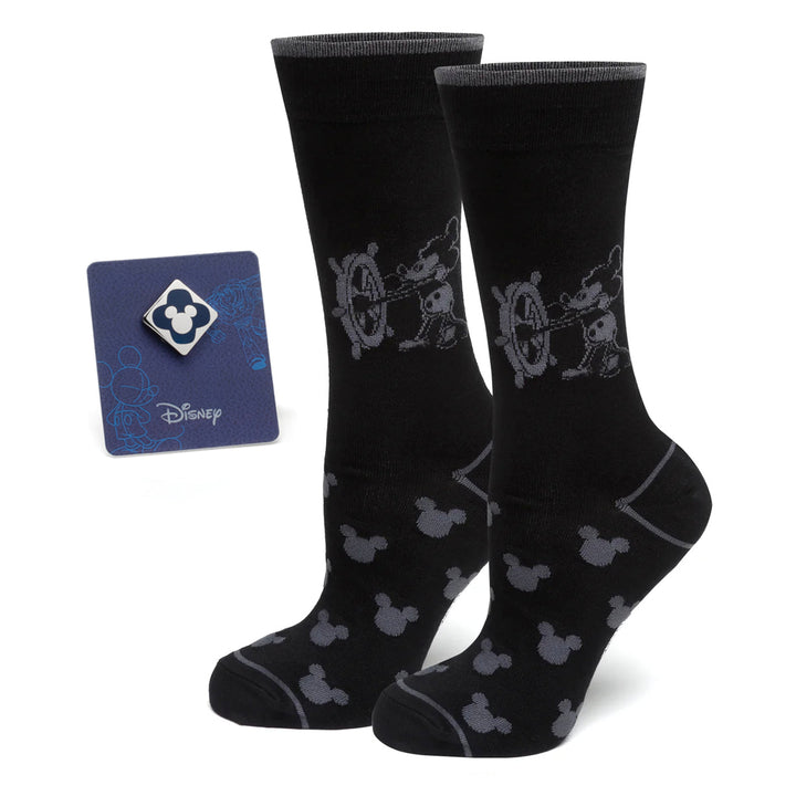 A Disney Mickey Mouse Steamboat Willie Sock and Mickey Blue Lapel Pin Gift Set featuring black crew socks with a Steamboat Willie design and a square Mickey Mouse icon pin on a blue backing card.