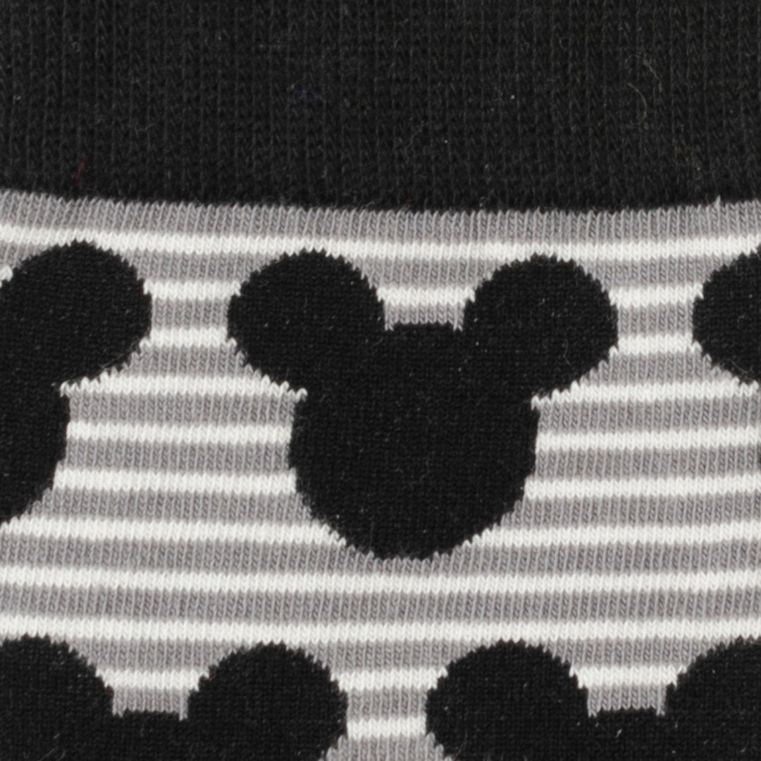 Close-up of a knit fabric featuring a repeating black silhouette of Mickey Mouse over thin horizontal gray and white stripes, as seen on the Disney Mickey Mouse Stripe Gray Sock and Mickey Blue Lapel Pin.
