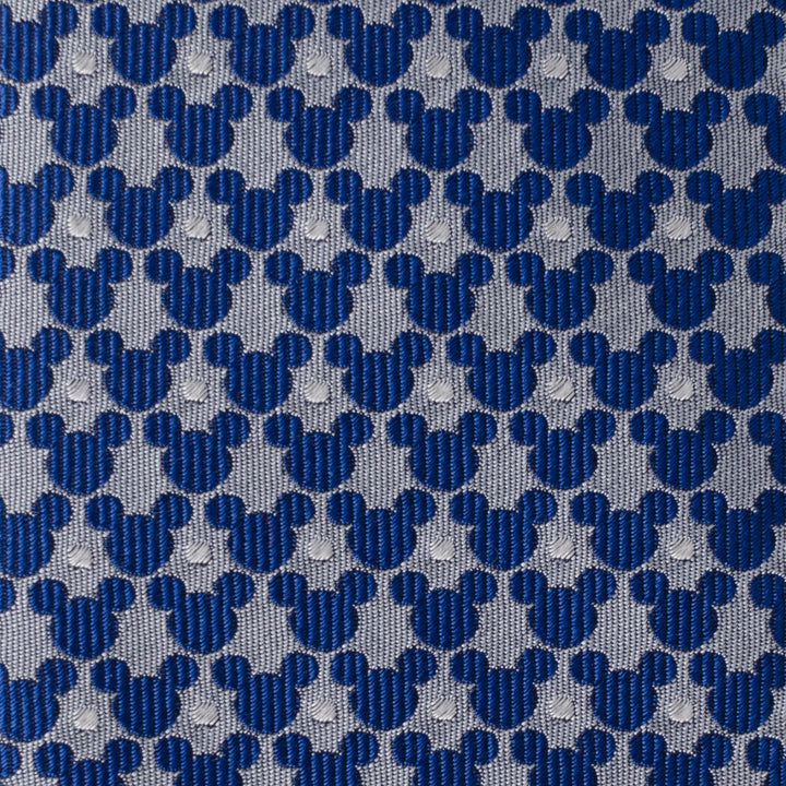 Disney Mickey Mouse Silhouette Pattern Dot Blue Tie with blue Mickey Mouse silhouettes and small white dots in a repeating pattern on a grey background.