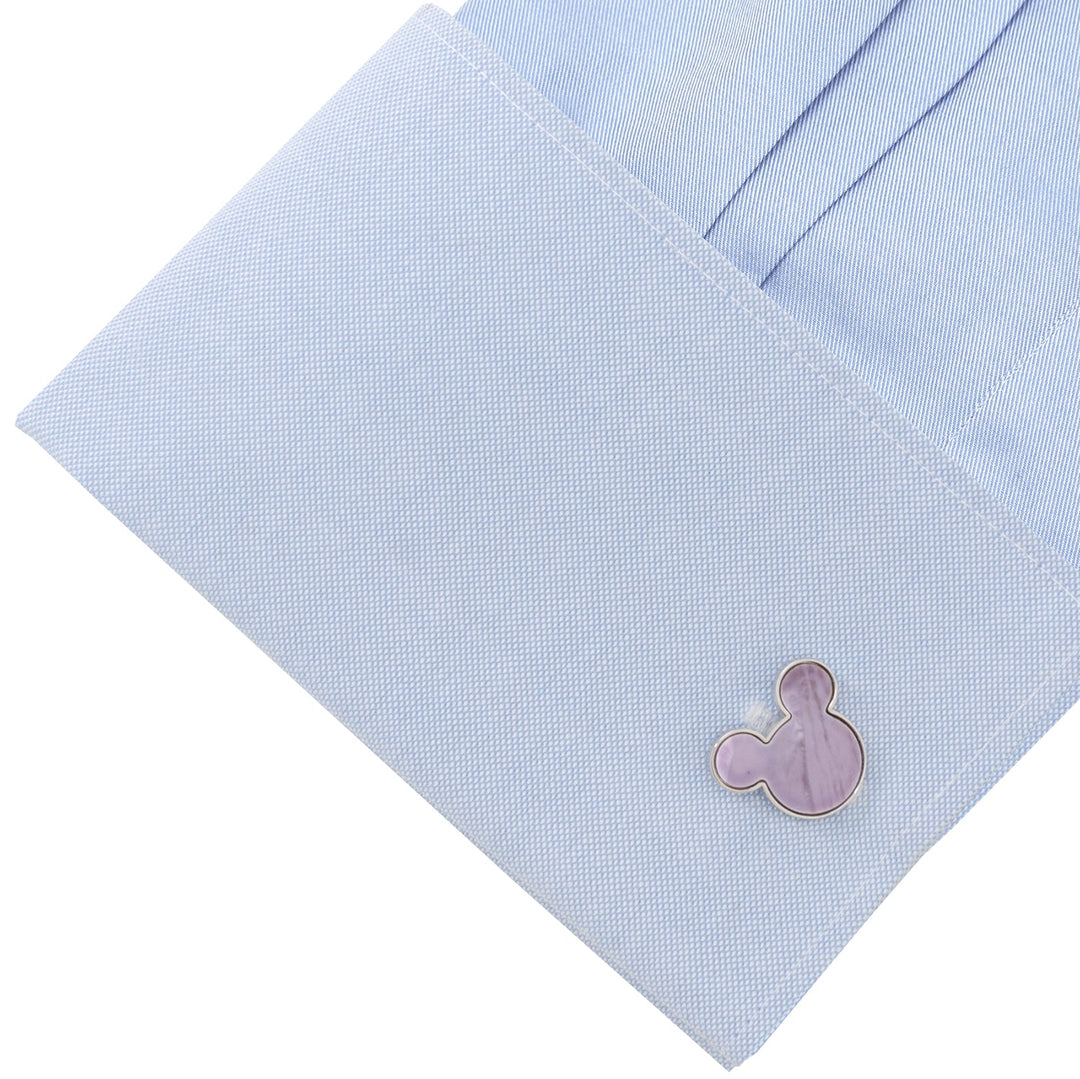 A Disney Mickey Mouse Silhouette Lavender Mother of Pearl Sterling Silver Cufflink fastened to a light blue shirt cuff.