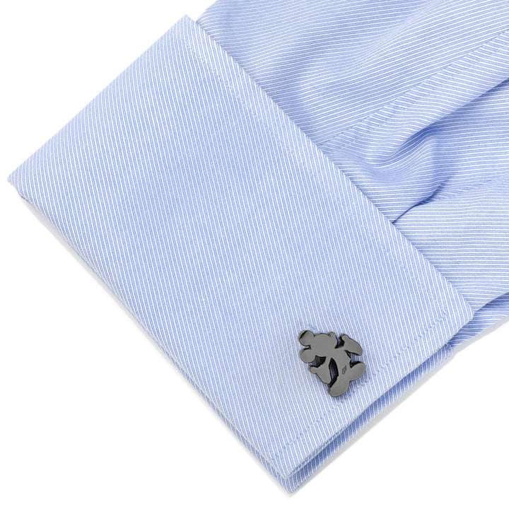 Dark metallic Disney Mickey Mouse Silhouette Cufflinks on a light blue, diagonal-striped French cuff shirt.