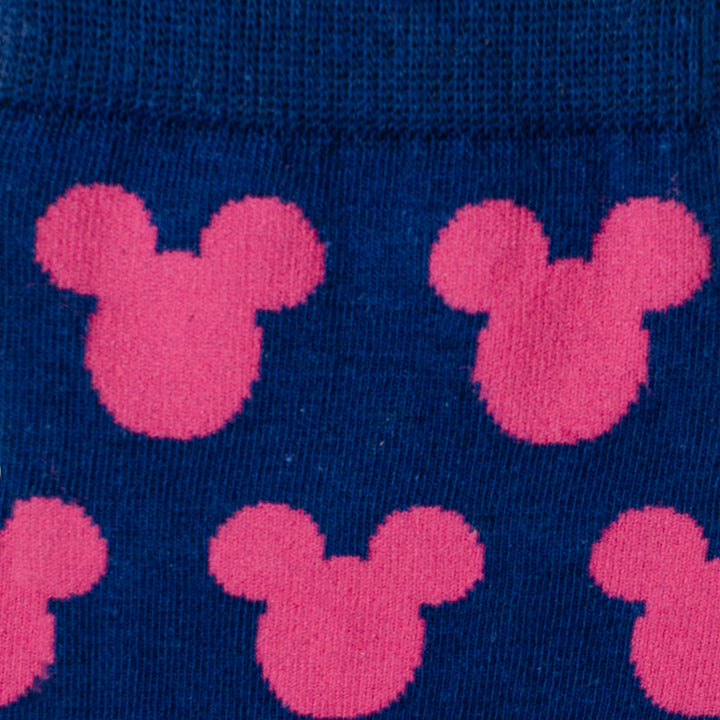 Dark blue fabric featuring a repeating pink Mickey silhouette pattern from the Disney Mickey Mouse Silhouette Pink Sock and Mickey Blue Lapel Pin Gift Set.