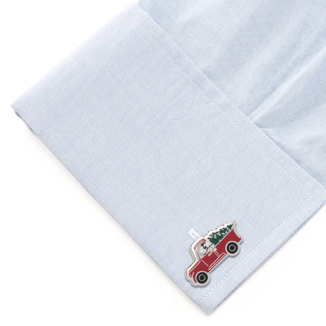 Disney Mickey Mouse Holiday Truck Cufflinks shaped like a truck carrying a Christmas tree, attached to a light blue shirt cuff.