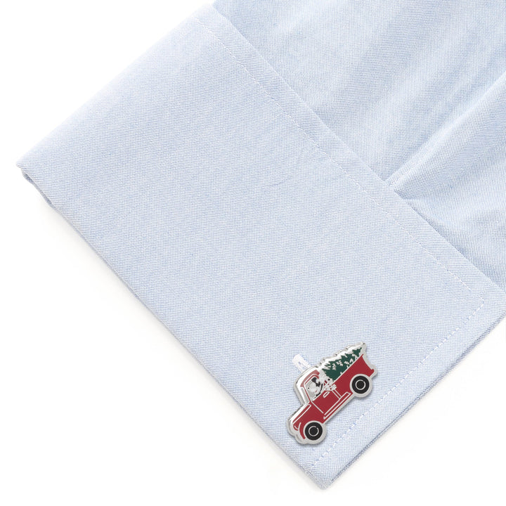 Disney Mickey Mouse Holiday Truck Cufflinks shaped like a truck carrying a Christmas tree, attached to a light blue shirt cuff.