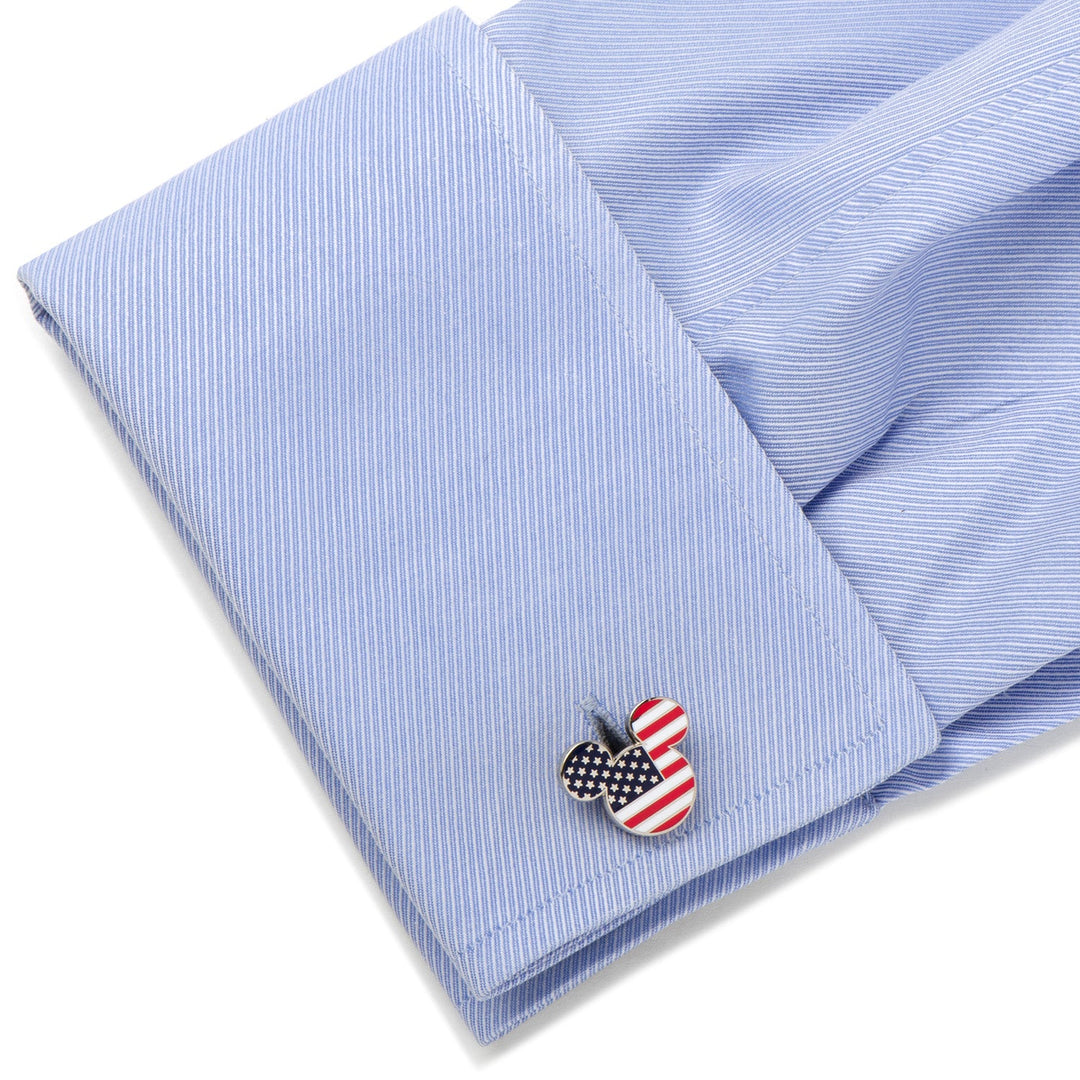 Disney Mickey Mouse Stars and Stripes Cufflinks featuring a Mickey Mouse shape with an American flag pattern, attached to a light blue dress shirt cuff.