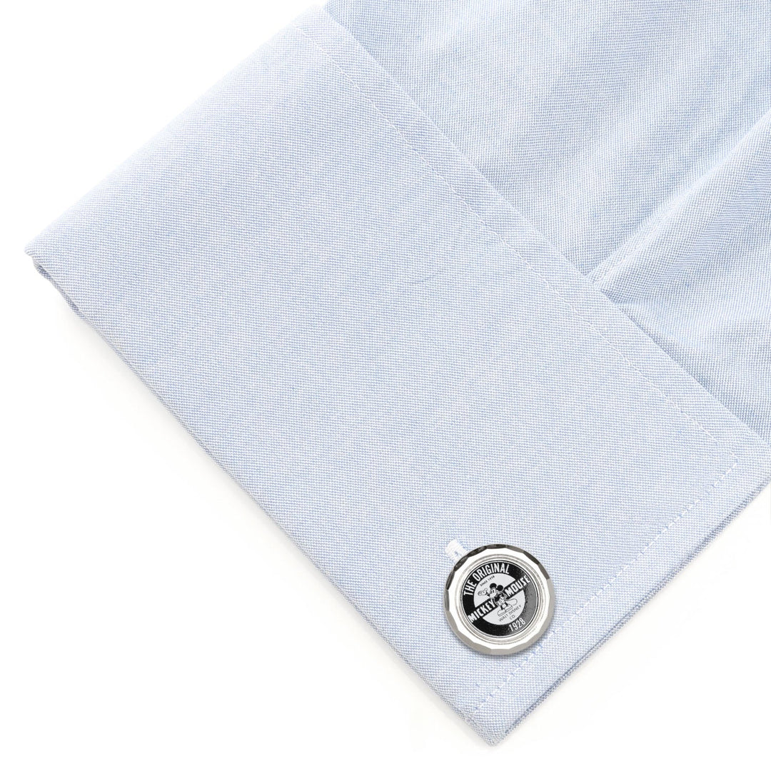 Disney Mickey Mouse Original Cufflinks: a round silver-tone cufflink featuring a vintage Mickey Mouse graphic, attached to a folded light blue dress shirt cuff.