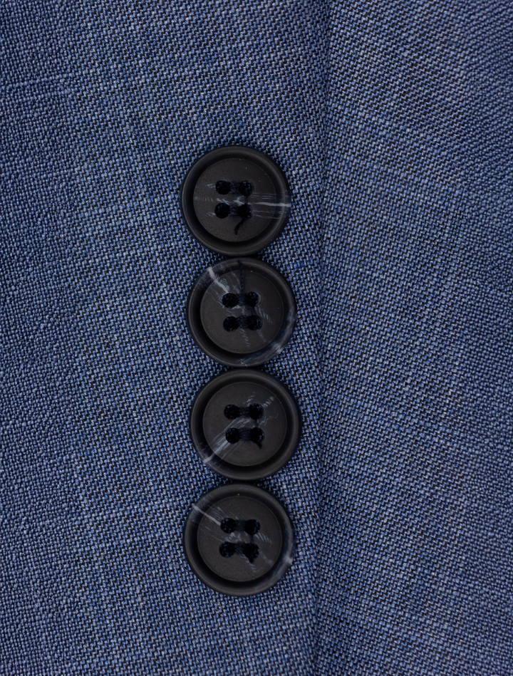 Close-up of a FUBU Stone Blue Peak Lapel Suit sleeve by Fubu The Colle, showing four black buttons in a vertical line and a Stretch Armhole for enhanced comfort.