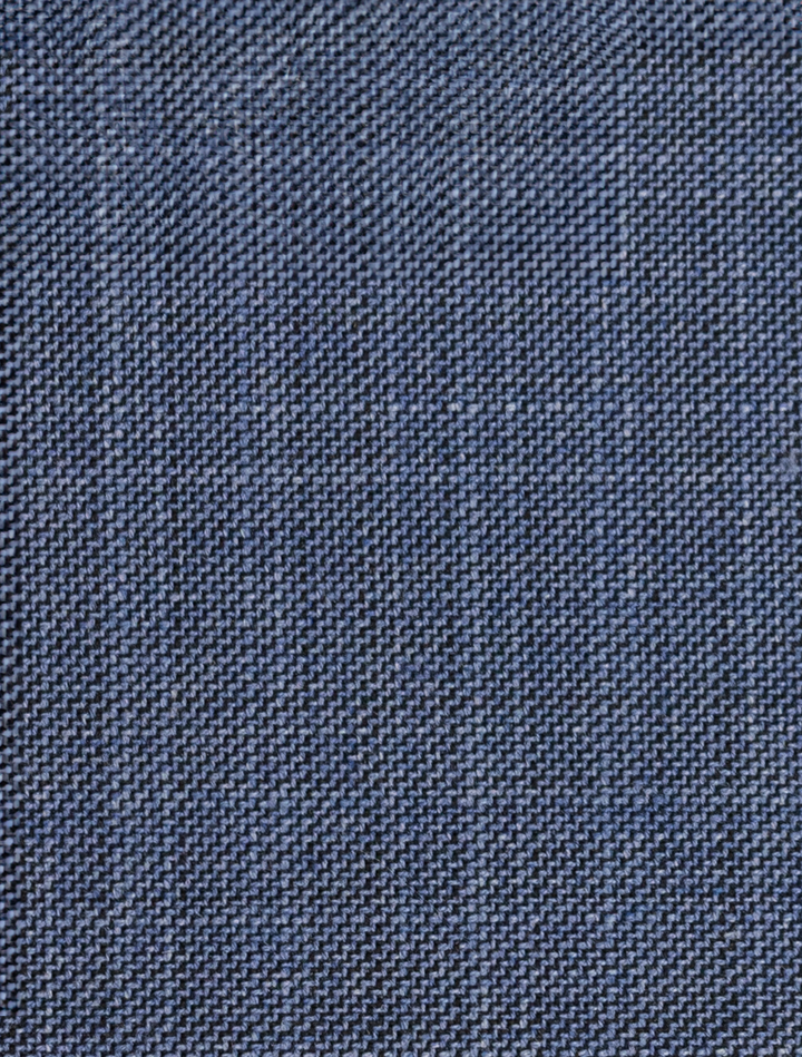 Close-up of FUBU Stone Blue Peak Lapel 2-Piece Suit fabric, its detailed weave pattern reminiscent of the craftsmanship found in modern fit suits from Fubu The Colle.