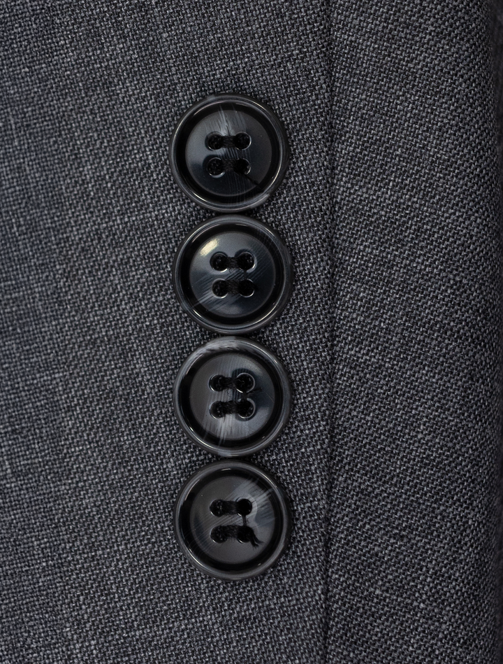 Close-up of four black buttons on the sleeve of a Fubu The Colle Iron Grey Peak Lapel 2-Piece Suit.