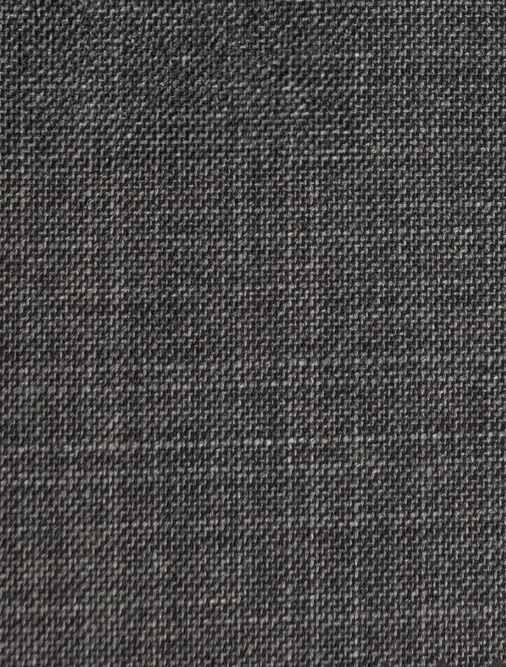 Close-up of FUBU Iron Grey Peak Lapel Suit from Fubu The Colle, showcasing its dark gray woven fabric texture and pattern—ideal for crafting a sleek, slim-fit suit.