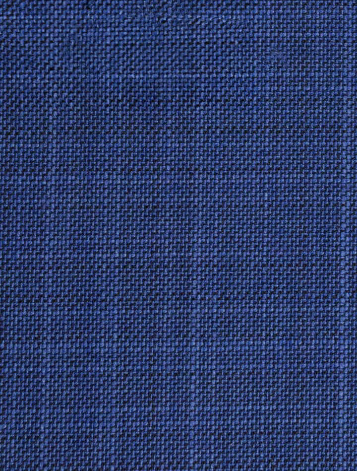 Close-up of fabric texture from the FUBU Cobalt Blue Peak Lapel Suit by Fubu The Colle, featuring a grid-like pattern reminiscent of modern fit design.