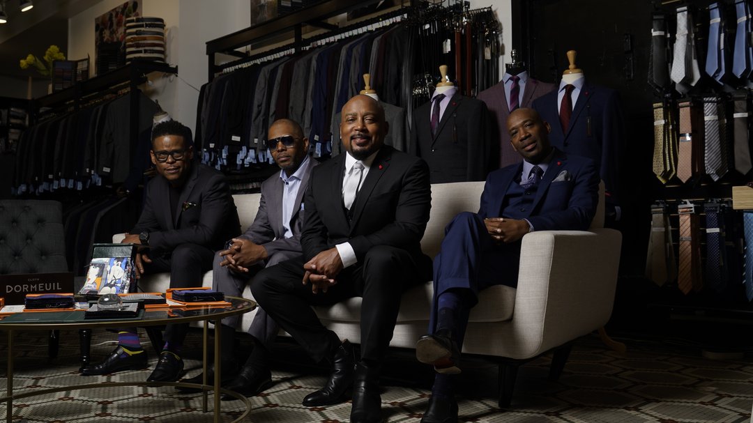 Shark Tank's Damon John featured with co-founders of FUBU. FUBU and Karako Suits have an exclusive agreement for Karako to make FUBU suits.