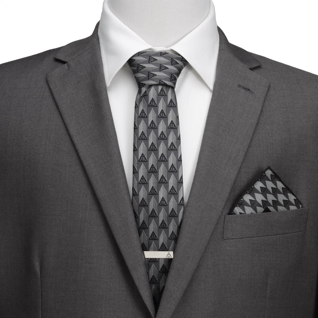 Harry Potter Deathly Hallows Gray Silk Men’s Tie worn with a white shirt, gray suit jacket, tie bar, and a geometric pocket square.