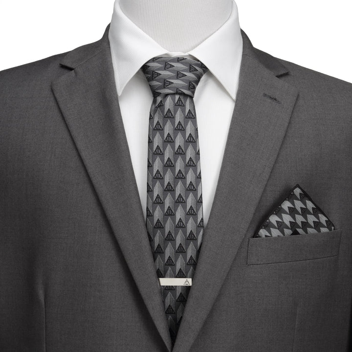 Harry Potter Deathly Hallows Gray Silk Men’s Tie worn with a white shirt, gray suit jacket, tie bar, and a geometric pocket square.