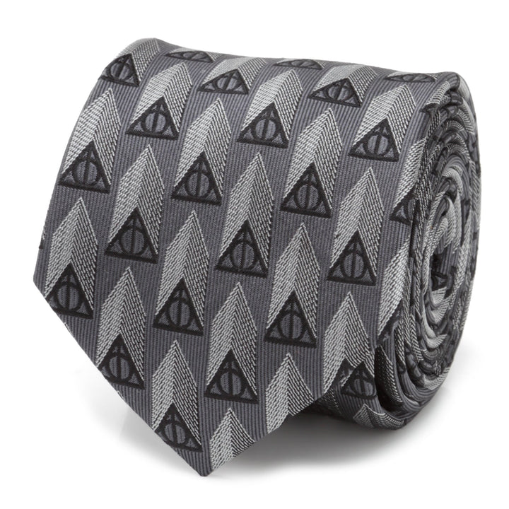 Harry Potter Deathly Hallows Gray Silk Men’s Tie featuring a repeating pattern of black Deathly Hallows symbols over light and dark gray chevron-style stripes.