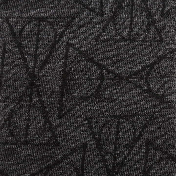 Harry Potter Deathly Hallows Black Men’s Socks are dark gray dress socks featuring a repeating black Deathly Hallows symbol pattern.