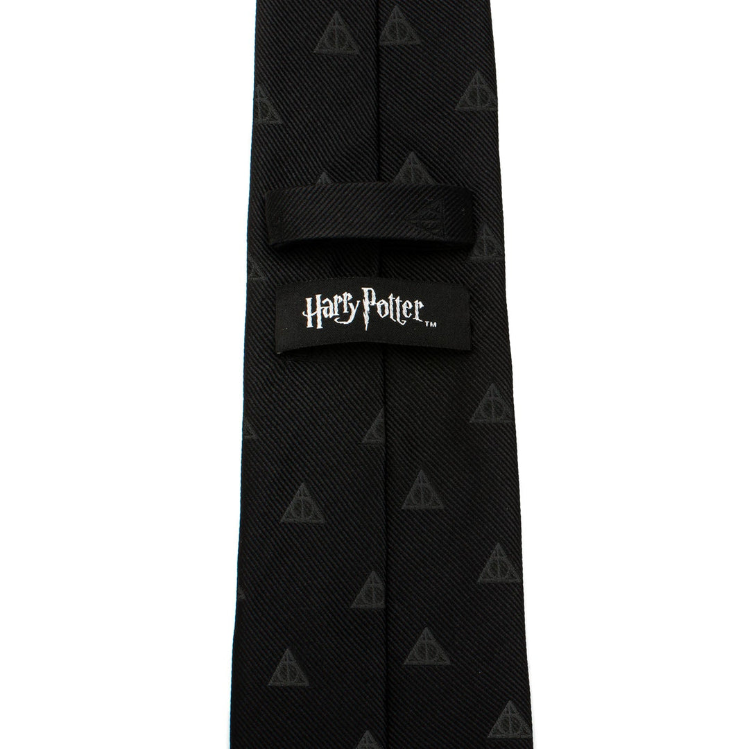 Black silk Harry Potter Deathly Hallows Tie featuring a repeating pattern and a branded label on the back.