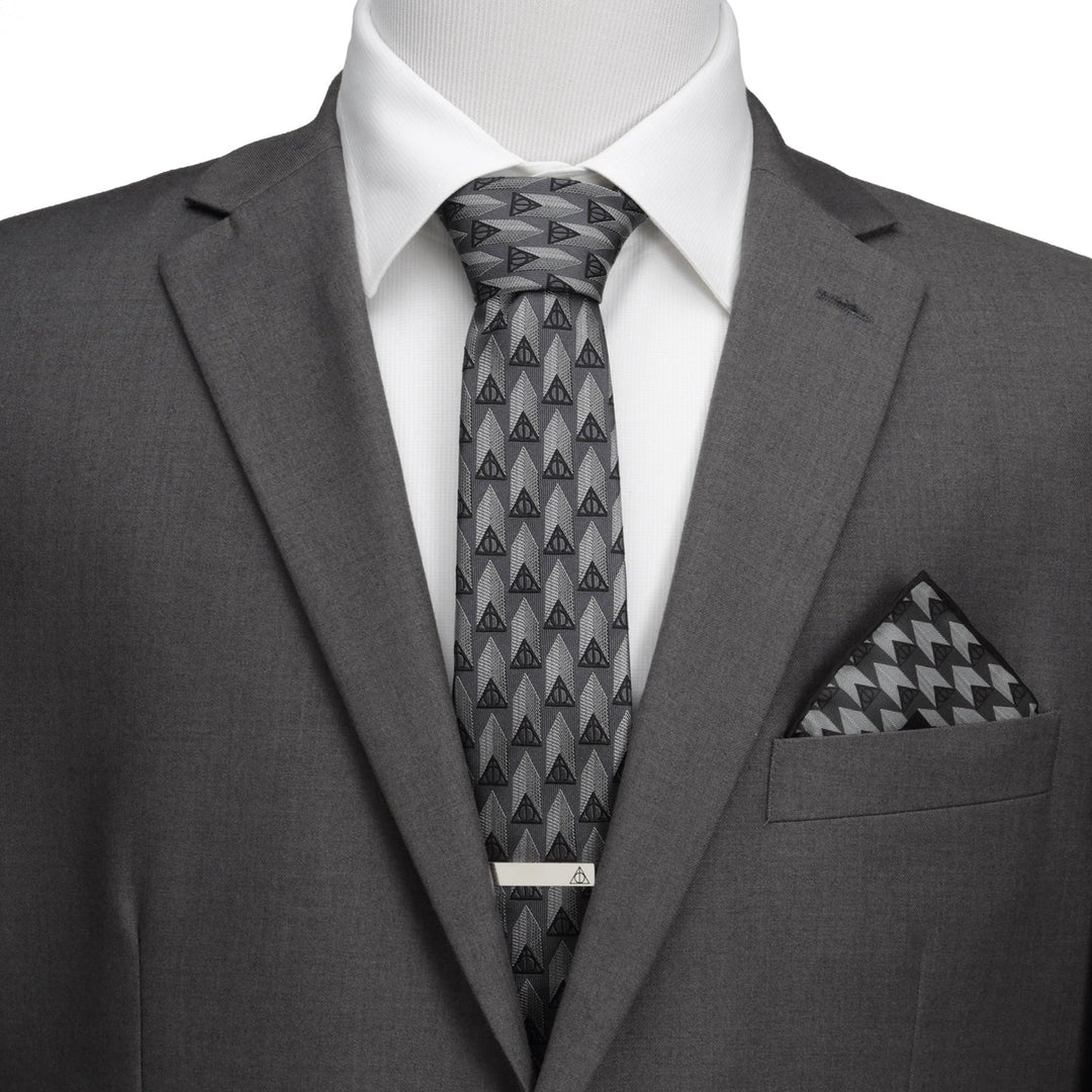Gray suit with a white shirt and a Harry Potter Deathly Hallows Gray Necktie Gift Set, featuring a matching pocket square and a silver tie bar.