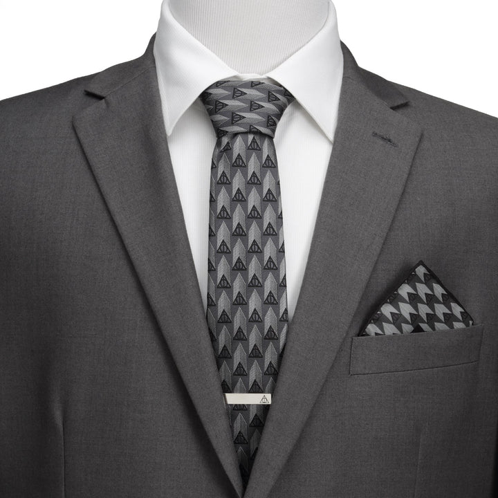 Gray suit with a white shirt and a Harry Potter Deathly Hallows Gray Necktie Gift Set, featuring a matching pocket square and a silver tie bar.