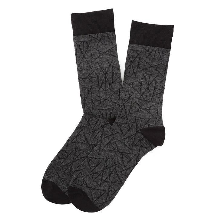 A pair of Harry Potter Deathly Hallows Gray Necktie Gift Set crew socks in gray with a black Deathly Hallows pattern, featuring black cuffs, heels, and toes.