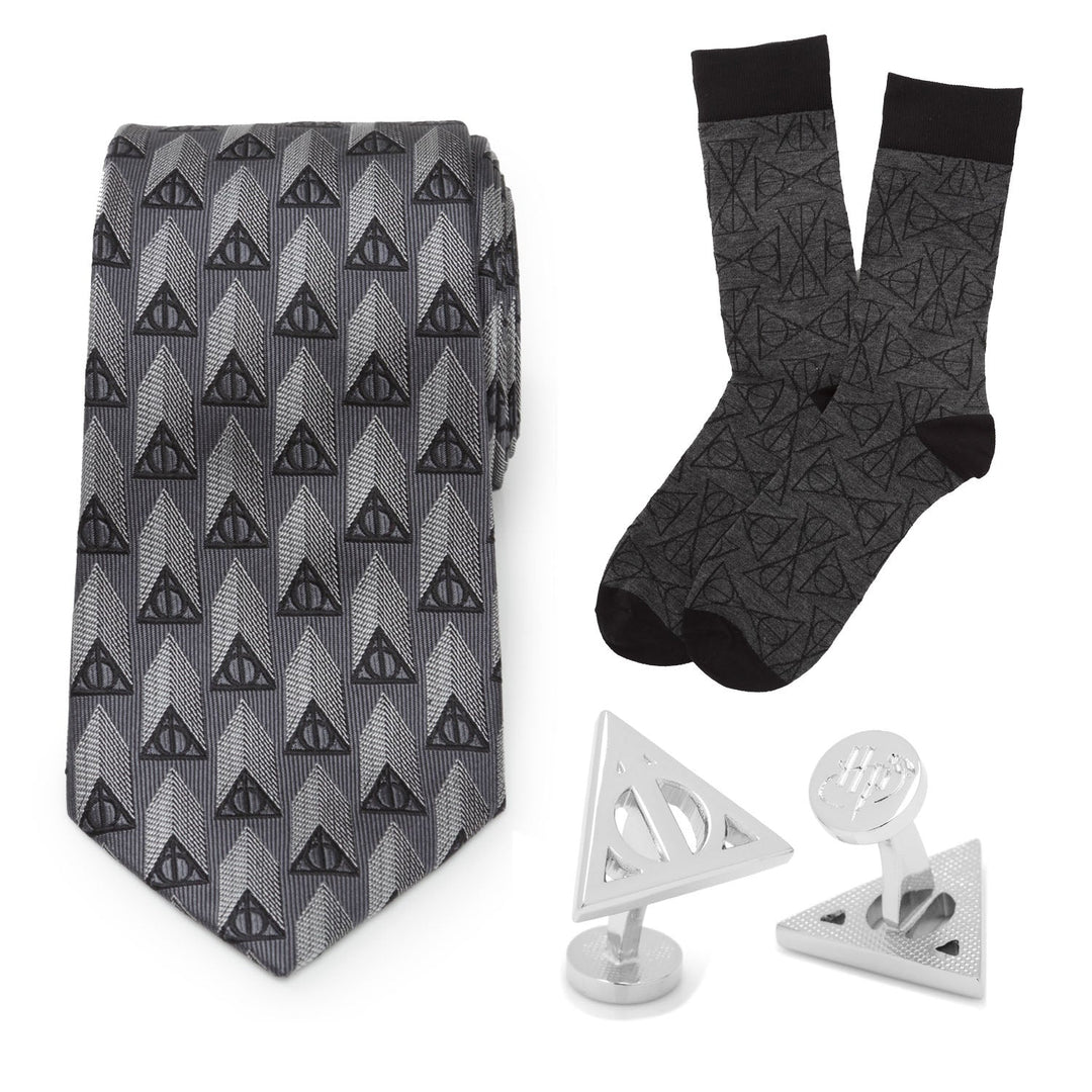 Harry Potter Deathly Hallows Gray Necktie Gift Set including a gray necktie, matching socks with a Deathly Hallows pattern, and two triangular metallic cufflinks.