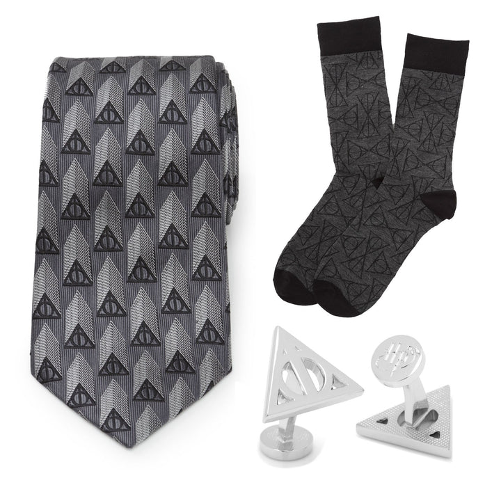 Harry Potter Deathly Hallows Gray Necktie Gift Set including a gray necktie, matching socks with a Deathly Hallows pattern, and two triangular metallic cufflinks.