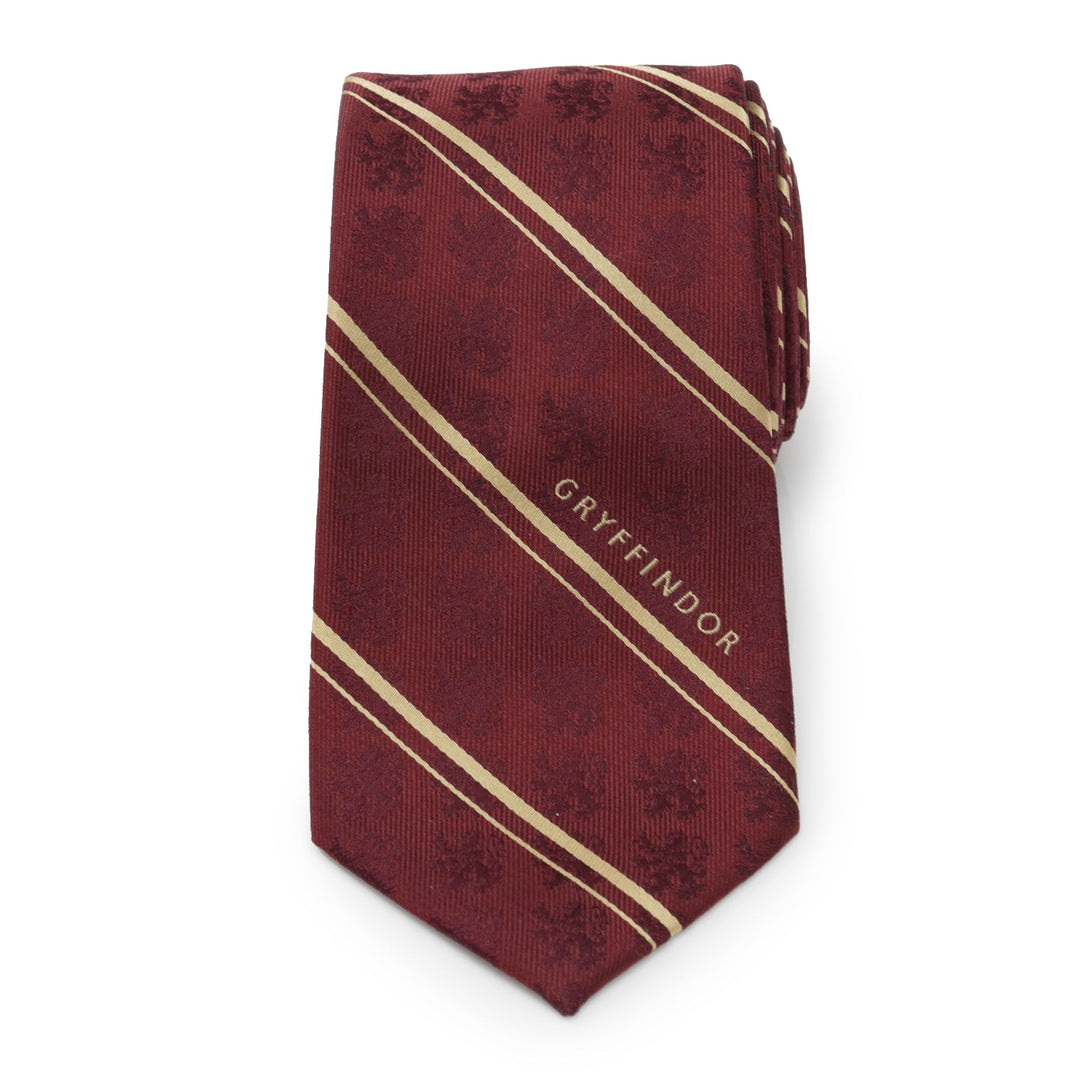 Harry Potter Gryffindor Maroon Stripe Silk Men’s Tie in maroon featuring thin gold diagonal stripes, a faint repeating lion pattern, and the word “GRYFFINDOR” printed along one stripe.