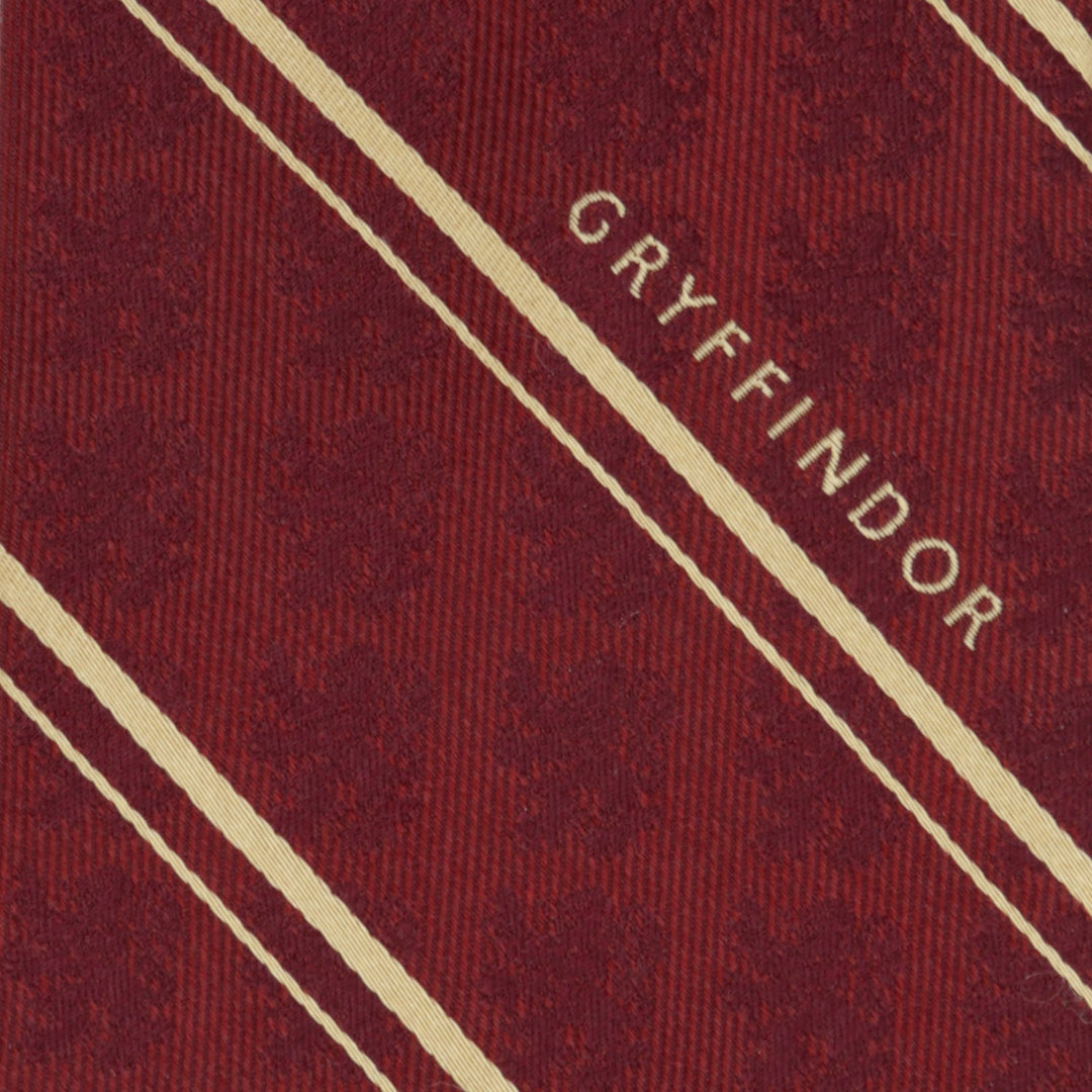 Harry Potter Gryffindor Maroon Stripe Silk Men’s Tie in maroon with diagonal gold stripes and the Hogwarts house name printed in gold.