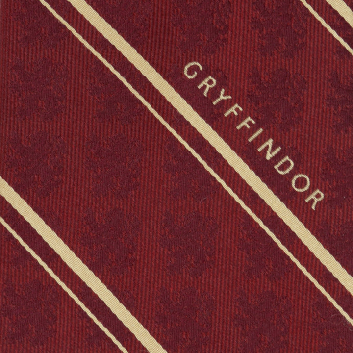 Harry Potter Gryffindor Maroon Stripe Silk Men’s Tie in maroon with diagonal gold stripes and the Hogwarts house name printed in gold.