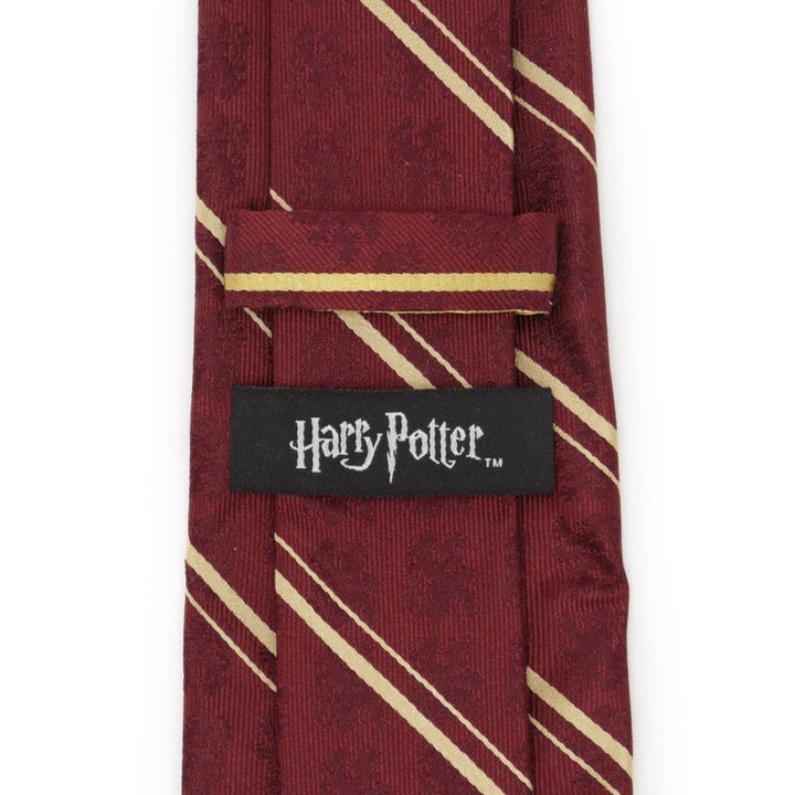Harry Potter Gryffindor Maroon Stripe Silk Men’s Tie in maroon with thin gold diagonal stripes and a black label featuring the Harry Potter logo.