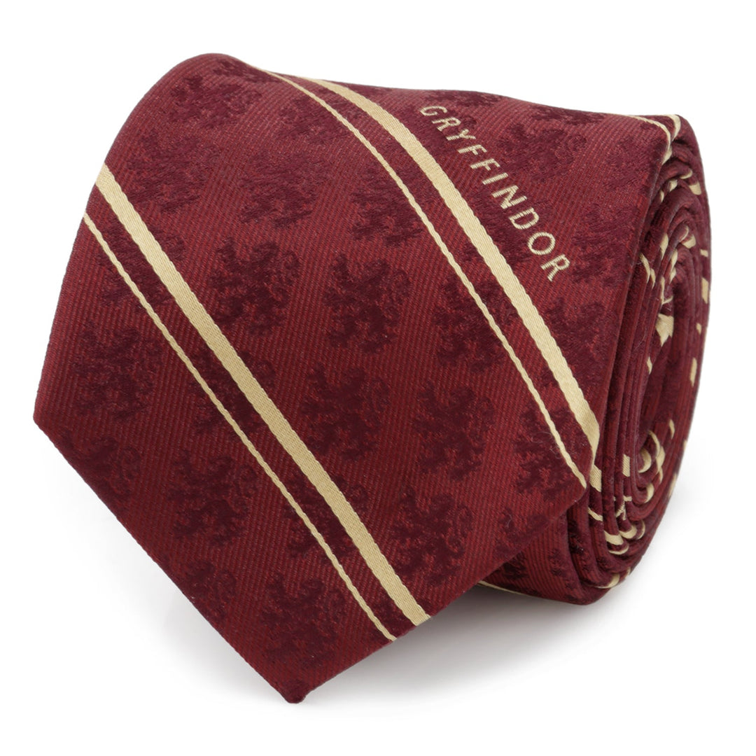 Harry Potter Gryffindor Maroon Stripe Silk Men’s Tie in maroon with tan stripes, a repeating lion pattern, and “GRYFFINDOR” embroidered near the tip.