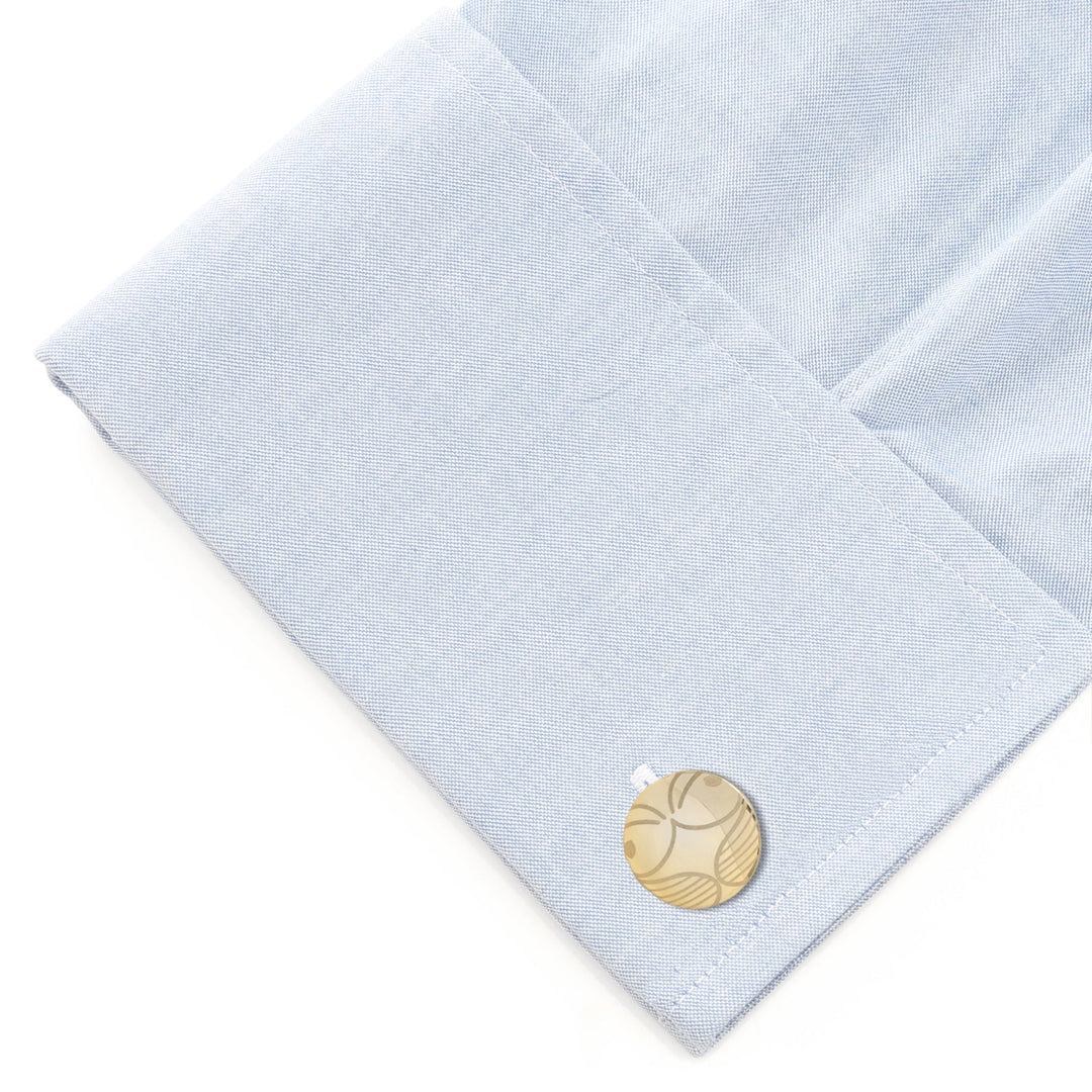 Harry Potter Golden Snitch Hidden Deathly Hallows Locket Cufflinks in a circular gold-toned design with an engraved winged sphere, shown on a light blue shirt cuff.