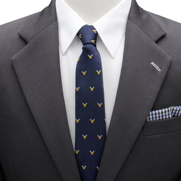 Harry Potter Golden Snitch Dot Tie in dark blue silk with small yellow winged spheres, worn with a charcoal suit, white shirt, and blue and white checkered pocket square.