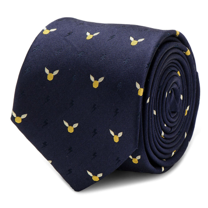 A rolled navy blue silk Harry Potter Golden Snitch Dot Tie by Cufflinks.com featuring a repeating pattern of small golden winged snitches and subtle lightning bolts.