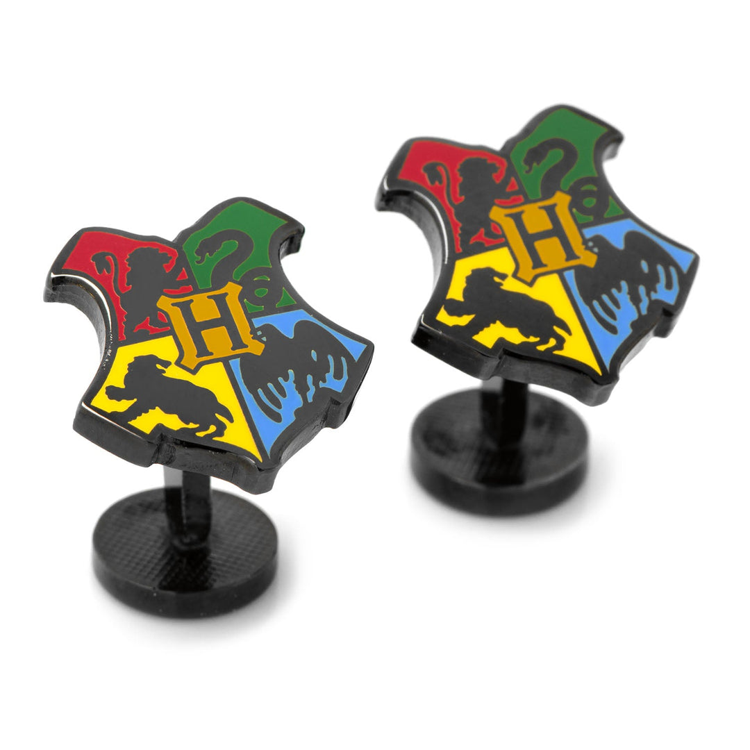 Two black metal Harry Potter Hogwarts Shield Cufflinks, each featuring a shield divided into four colored sections containing an “H” and symbols representing a lion, snake, badger, and eagle.