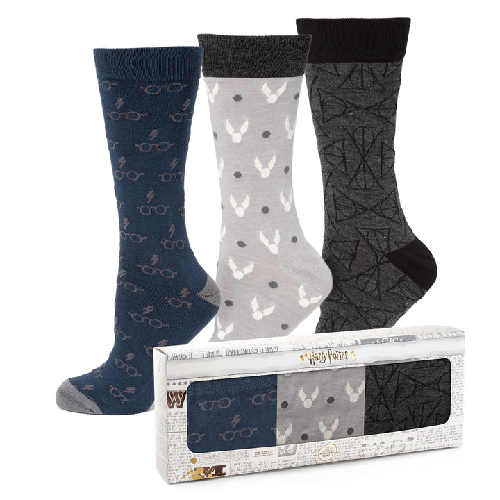 Three pairs of Harry Potter 3 Pack Sock Gift Set socks featuring themed patterns, displayed alongside their branded display box.