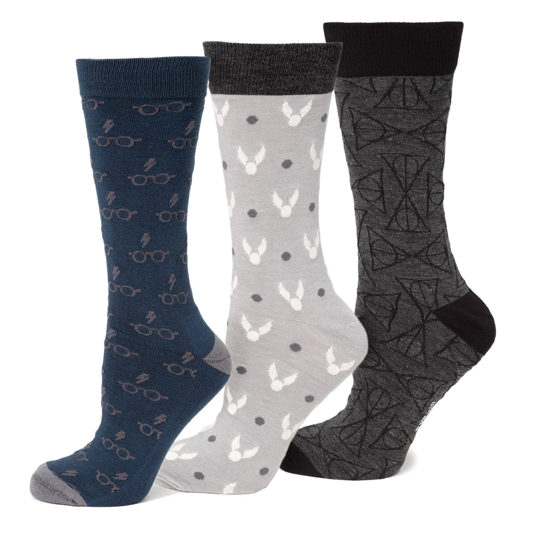 Harry Potter 3 Pack Sock Gift Set featuring one navy pair with glasses and lightning bolts, one grey pair with winged balls, and one dark grey pair with geometric symbols.