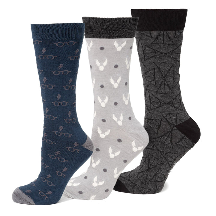 Harry Potter 3 Pack Sock Gift Set featuring one navy pair with glasses and lightning bolts, one grey pair with winged balls, and one dark grey pair with geometric symbols.