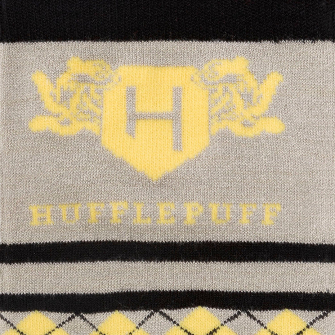 Harry Potter Hufflepuff Men’s Sock in grey, featuring a yellow H emblem, “HUFFLEPUFF” text, and a yellow argyle pattern bordered by black stripes.