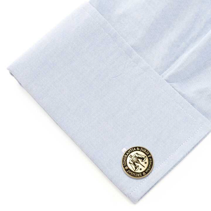 Harry Potter Ministry of Magic Wizengamot Cufflinks featuring a round scale of justice emblem and Latin text, worn on a light blue shirt cuff.