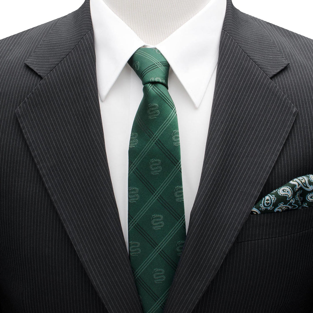A Harry Potter Slytherin Plaid Tie in green with a subtle serpent logo, worn with a white dress shirt and a dark pinstripe suit jacket featuring a patterned pocket square.
