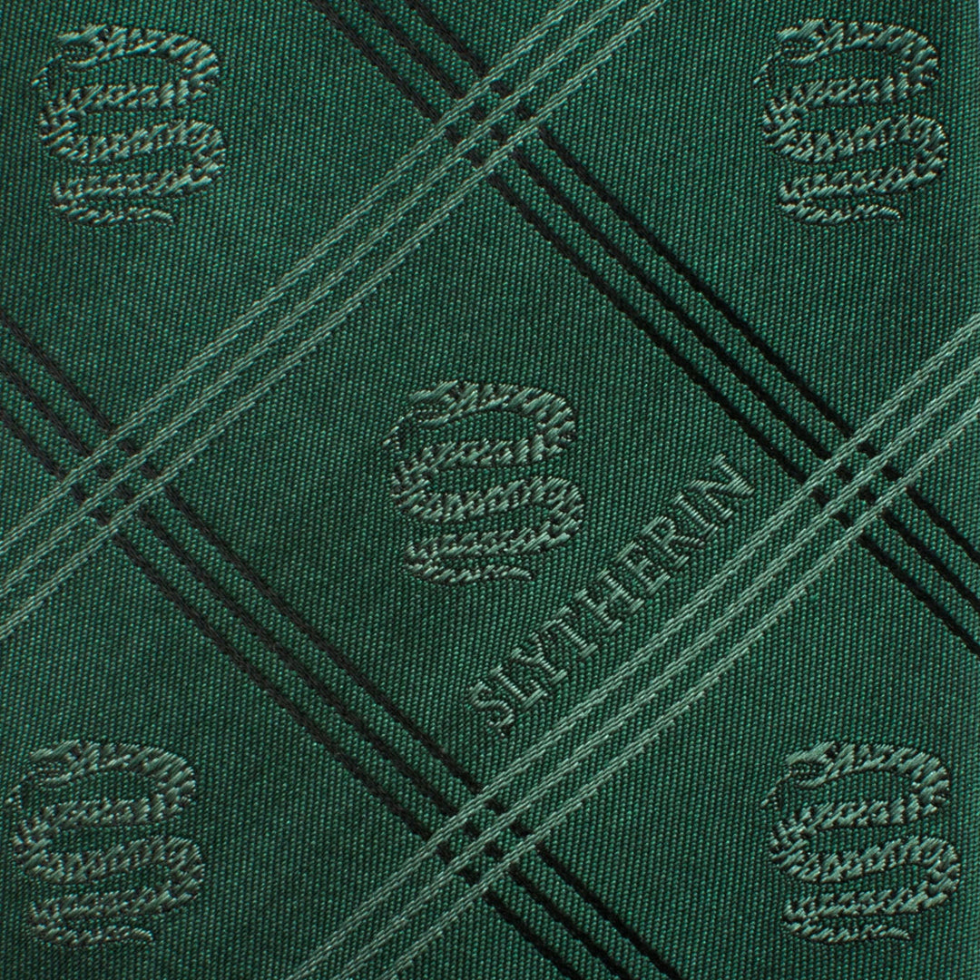 Harry Potter Slytherin Plaid Tie in green, featuring a black diagonal pattern with repeating serpent emblems and the word “SLYTHERIN.”