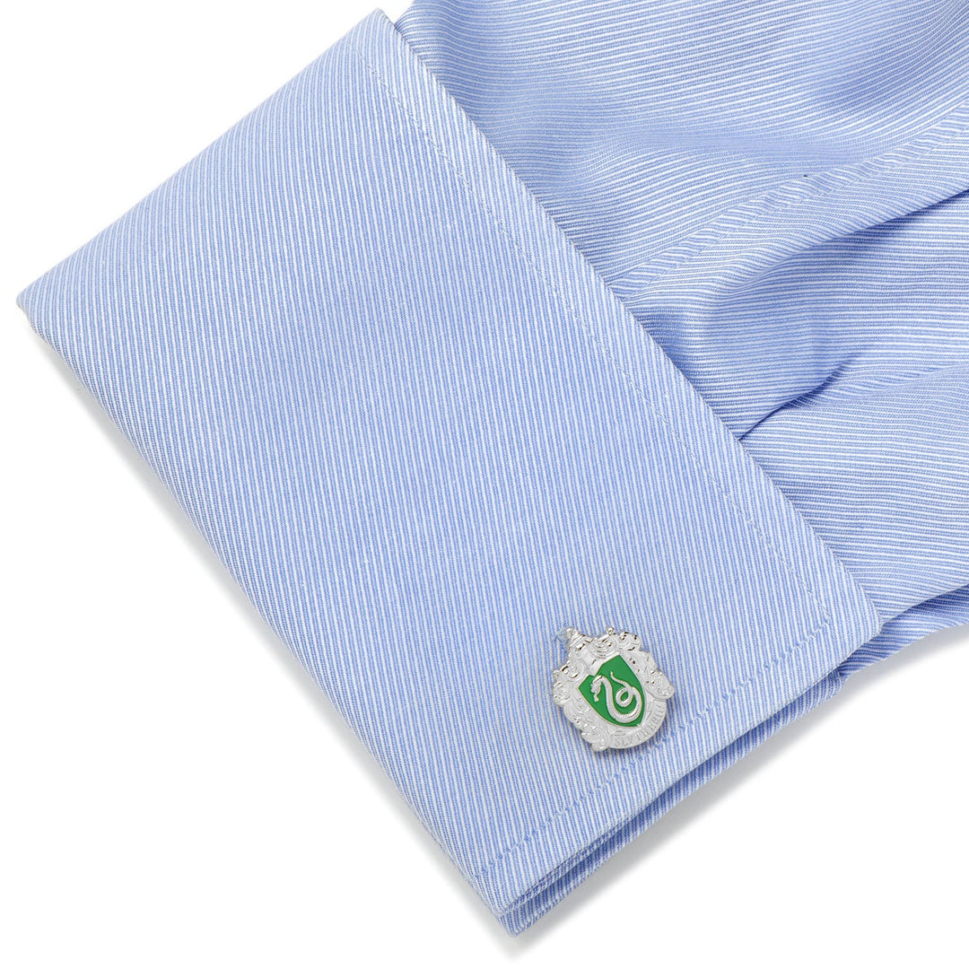Harry Potter Slytherin Crest Cufflinks featuring a silver design with a green snake crest on a light blue striped shirt cuff.